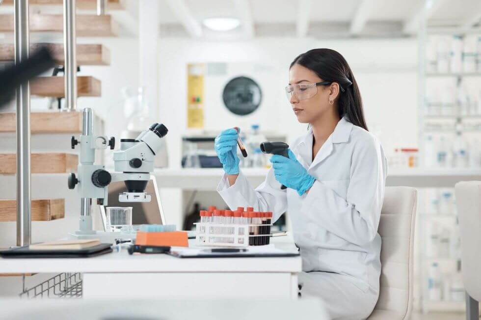 Scientist scanning blood sample barcodes